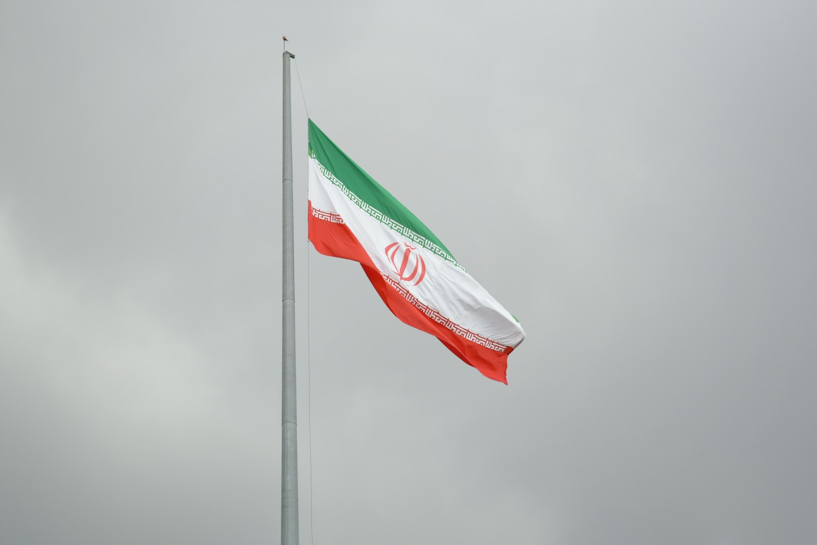 A flag flying in the wind on a cloudy day
