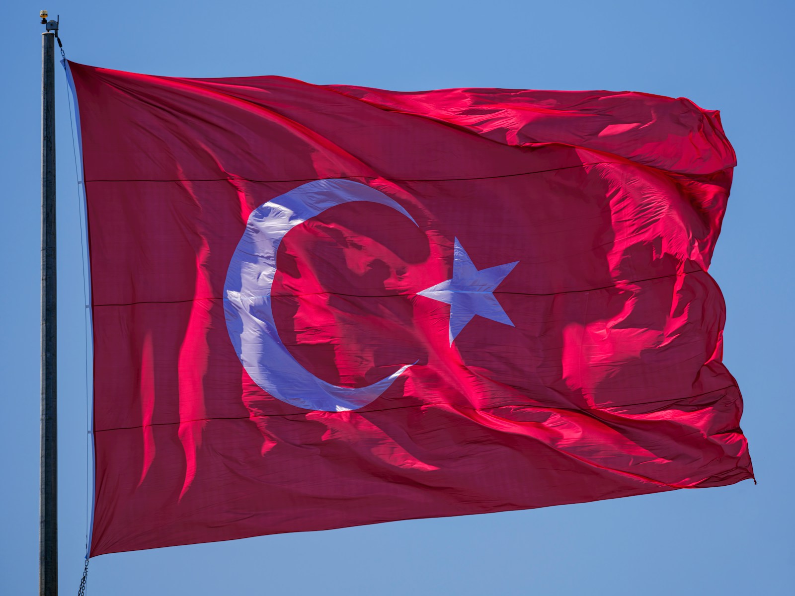 The turkish flag waves in the wind.