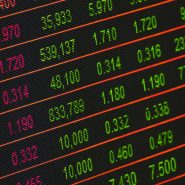 Close-up of a digital stock market data display showing colorful financial numbers and trends.