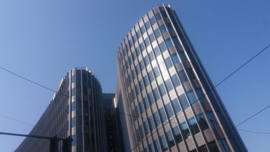 white and black concrete building under blue sky during daytime