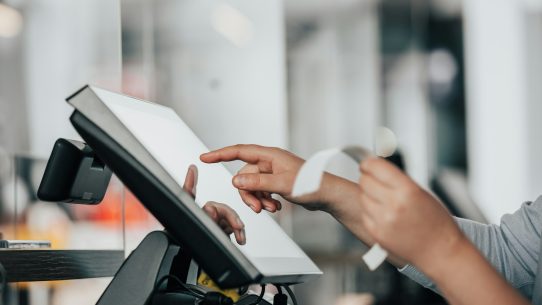 a person is using a pos machine in a store
