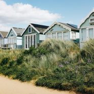 a row of beach houses sitting next to each other