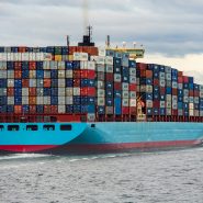 blue and red cargo ship on sea during daytime