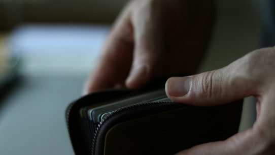 a person holding a wallet in their hand