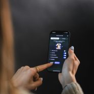 Woman's hand holding and touching smartphone screen of a smartphone