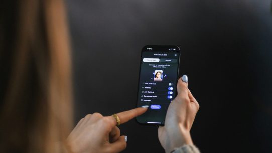 Woman's hand holding and touching smartphone screen of a smartphone