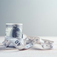 a roll of one hundred dollar bills wrapped in tape