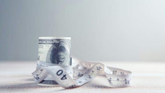 a roll of one hundred dollar bills wrapped in tape