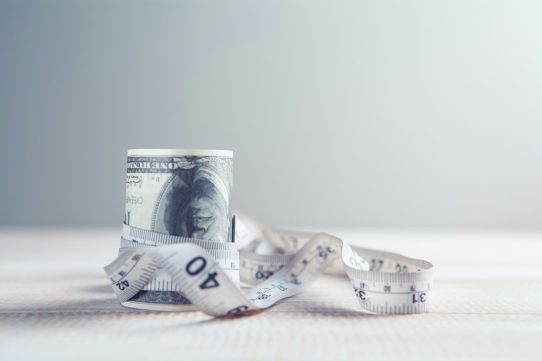 a roll of one hundred dollar bills wrapped in tape