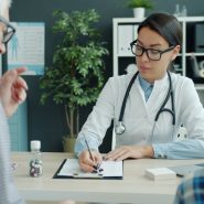 Doctor consults with elderly man and child.