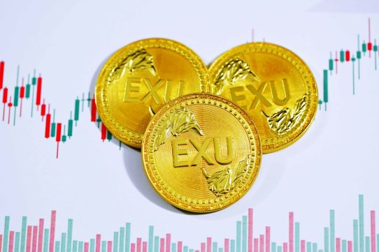 gold round coin on white surface