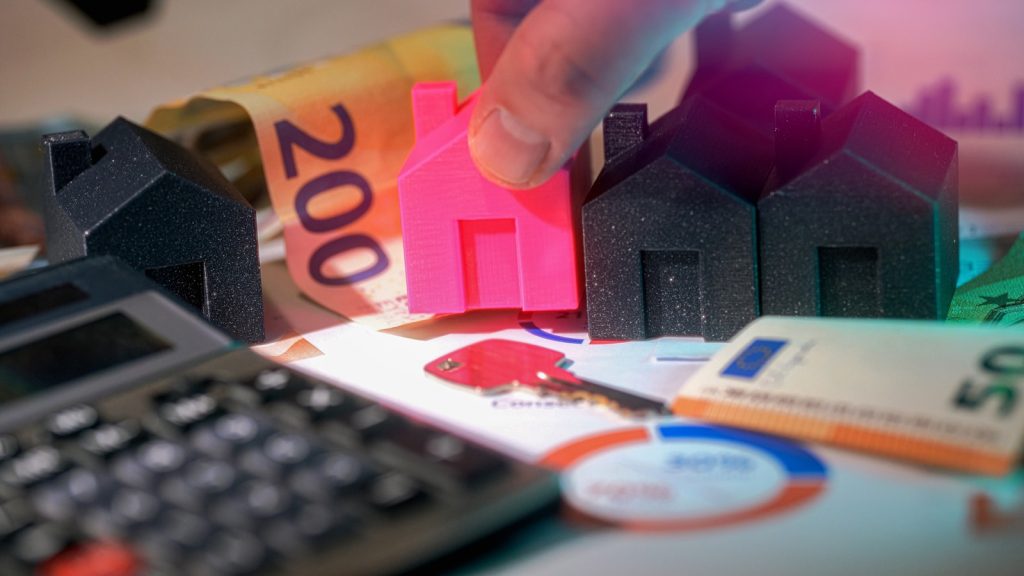 Real estate investment shown with houses and money.