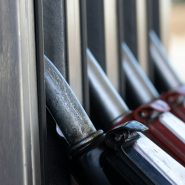 a row of knives hanging on the side of a building