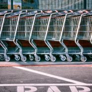 red and silver shopping cart on gray asphalt road during daytime