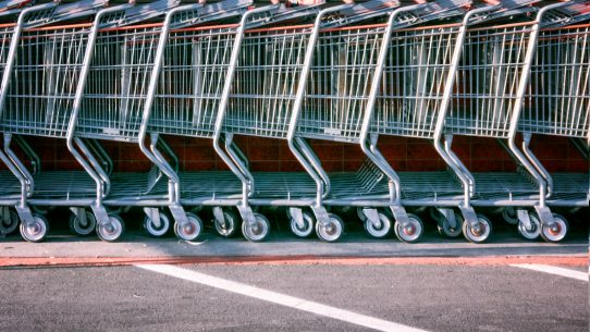red and silver shopping cart on gray asphalt road during daytime