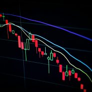 stock market candlestick chart on dark screen