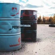 two gray and black metal barrels under cloudy sky