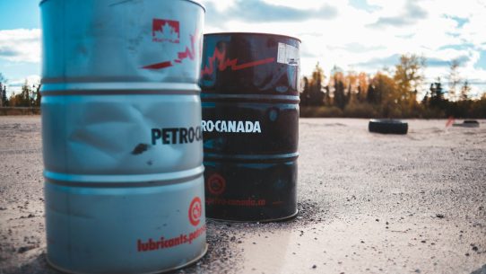 two gray and black metal barrels under cloudy sky