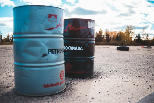 two gray and black metal barrels under cloudy sky
