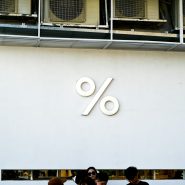 White wall with a large percent sign logo