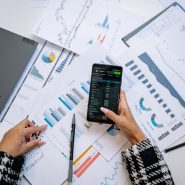 A top view on charts and smartphone in an office, showcasing data analytics.