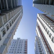 looking up at tall buildings in a city
