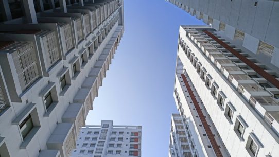 looking up at tall buildings in a city