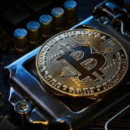 a bitcoin on top of a computer motherboard