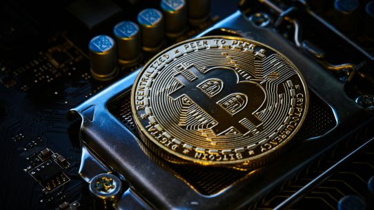 a bitcoin on top of a computer motherboard