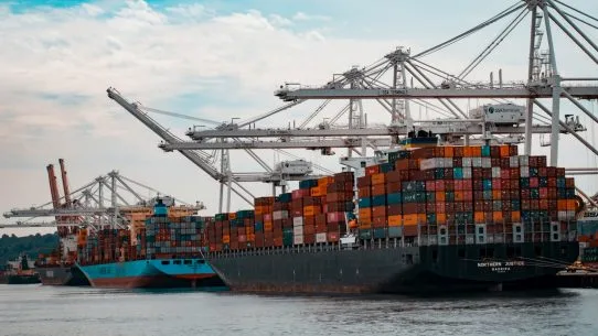 cargo ships docked at the pier during day