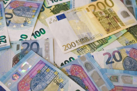 A scattered pile of various euro banknotes including twenty, one hundred, and two hundred denominations