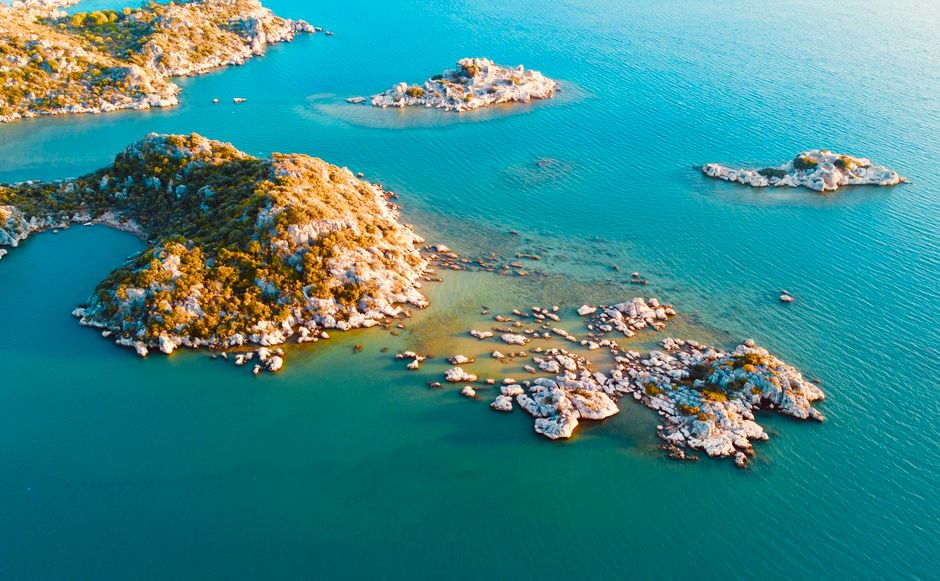 Drone capture of rocky islands surrounded by beautiful azure sea.