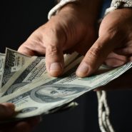 person holding 100 us dollar bill