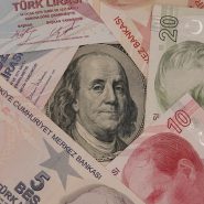 a pile of different currency sitting on top of each other