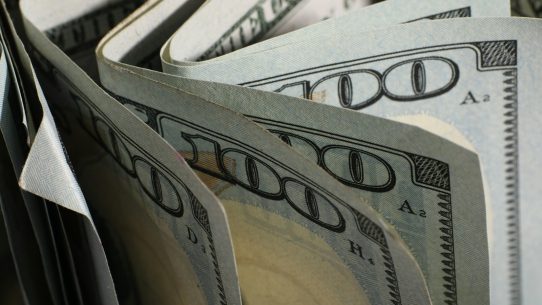 A close-up of us hundred dollar bills fanned out
